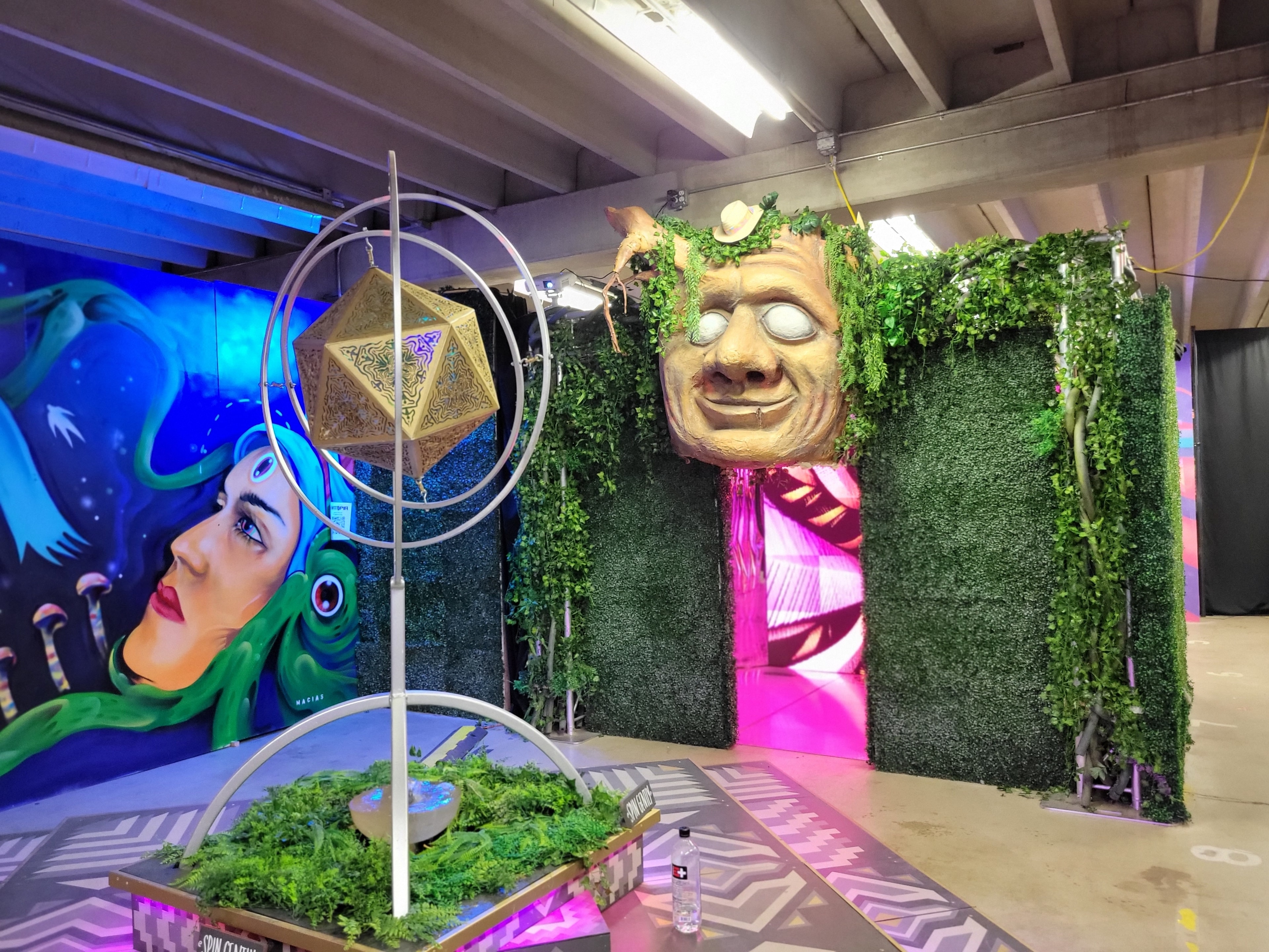 Artopia giant face sculpture, ivy wall, and immersive installation environment