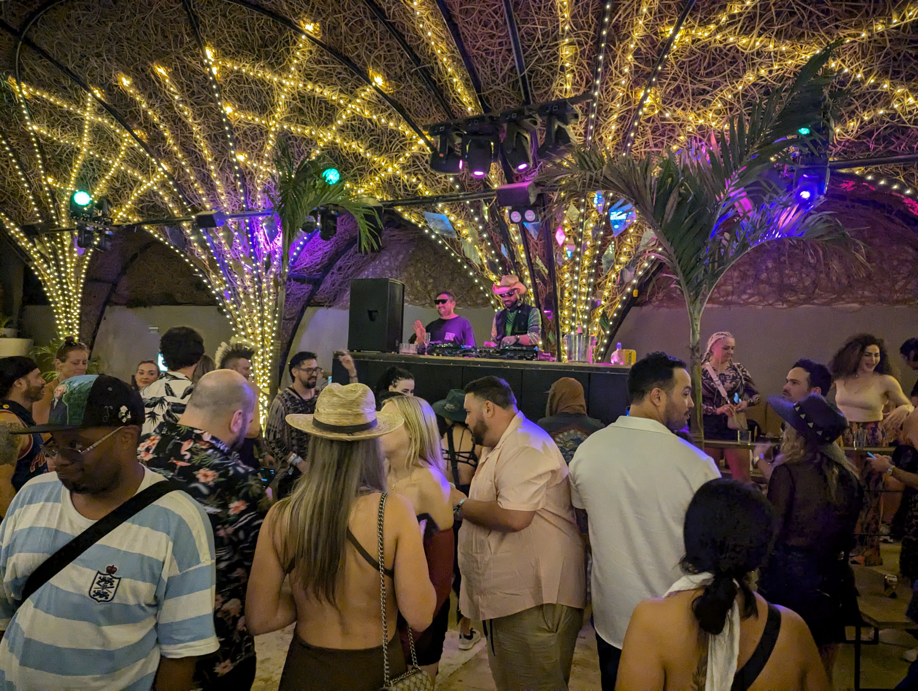 Venue with warm fairy lights and DJ booth at Destination Unknown