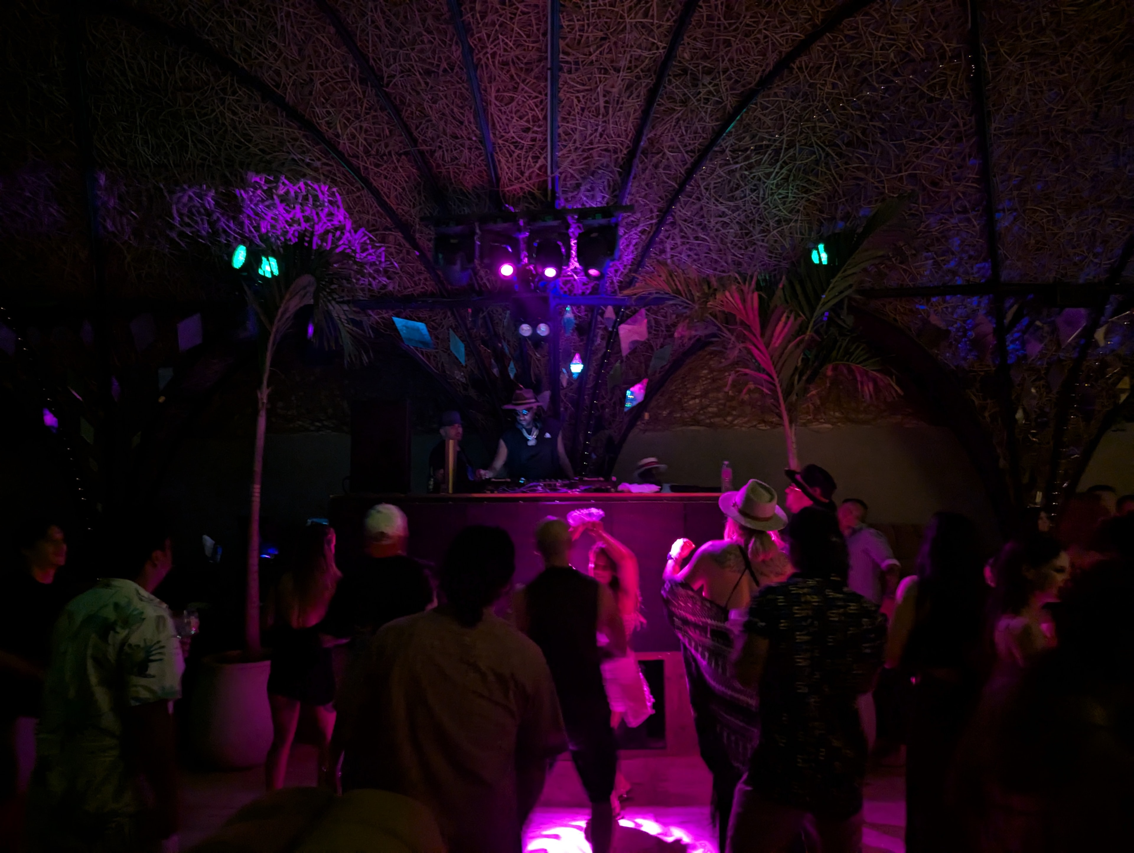 DJ performing under pink and magenta lights at Destination Unknown