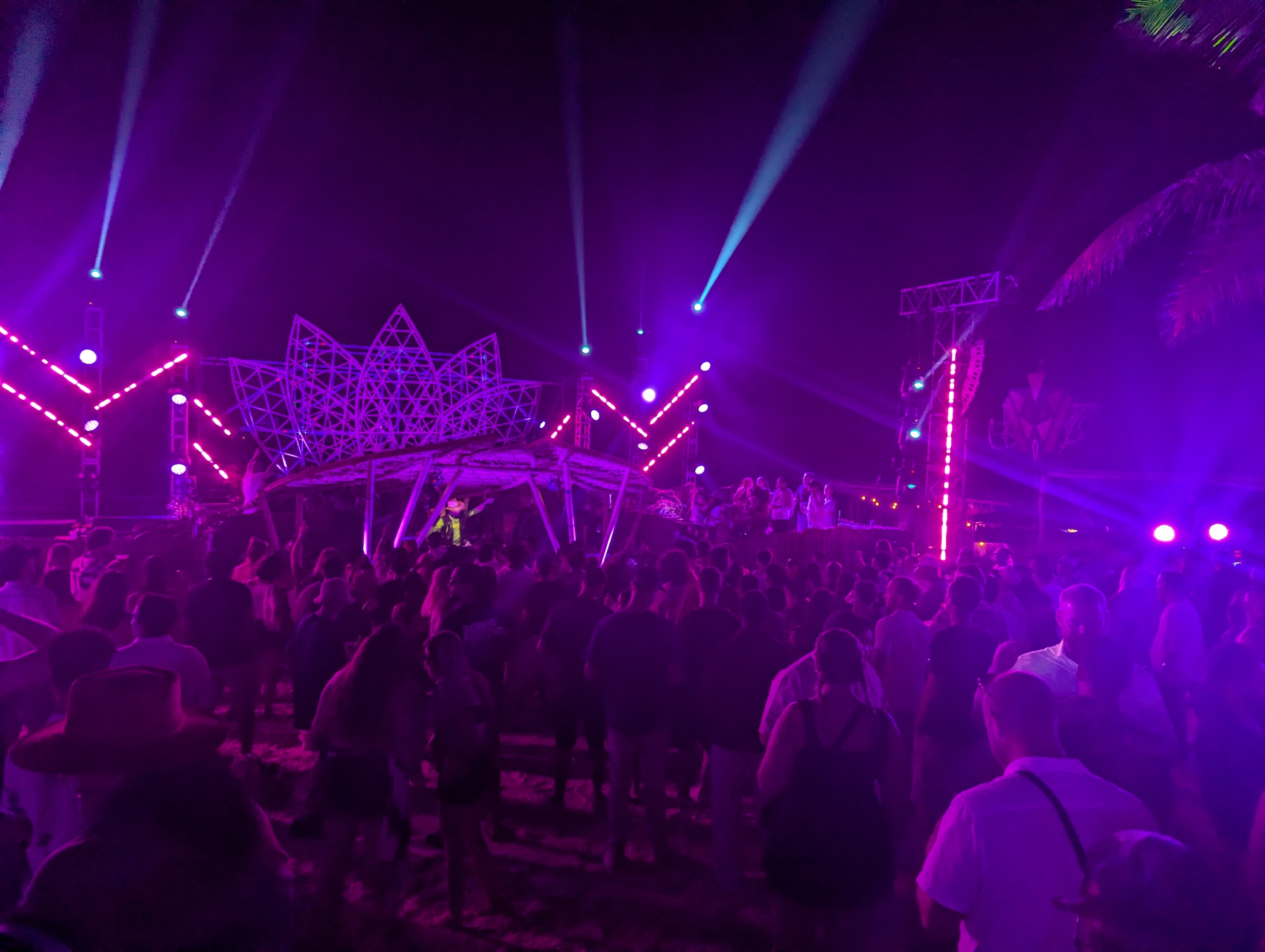 Crowd under purple lights at Destination Unknown outdoor stage