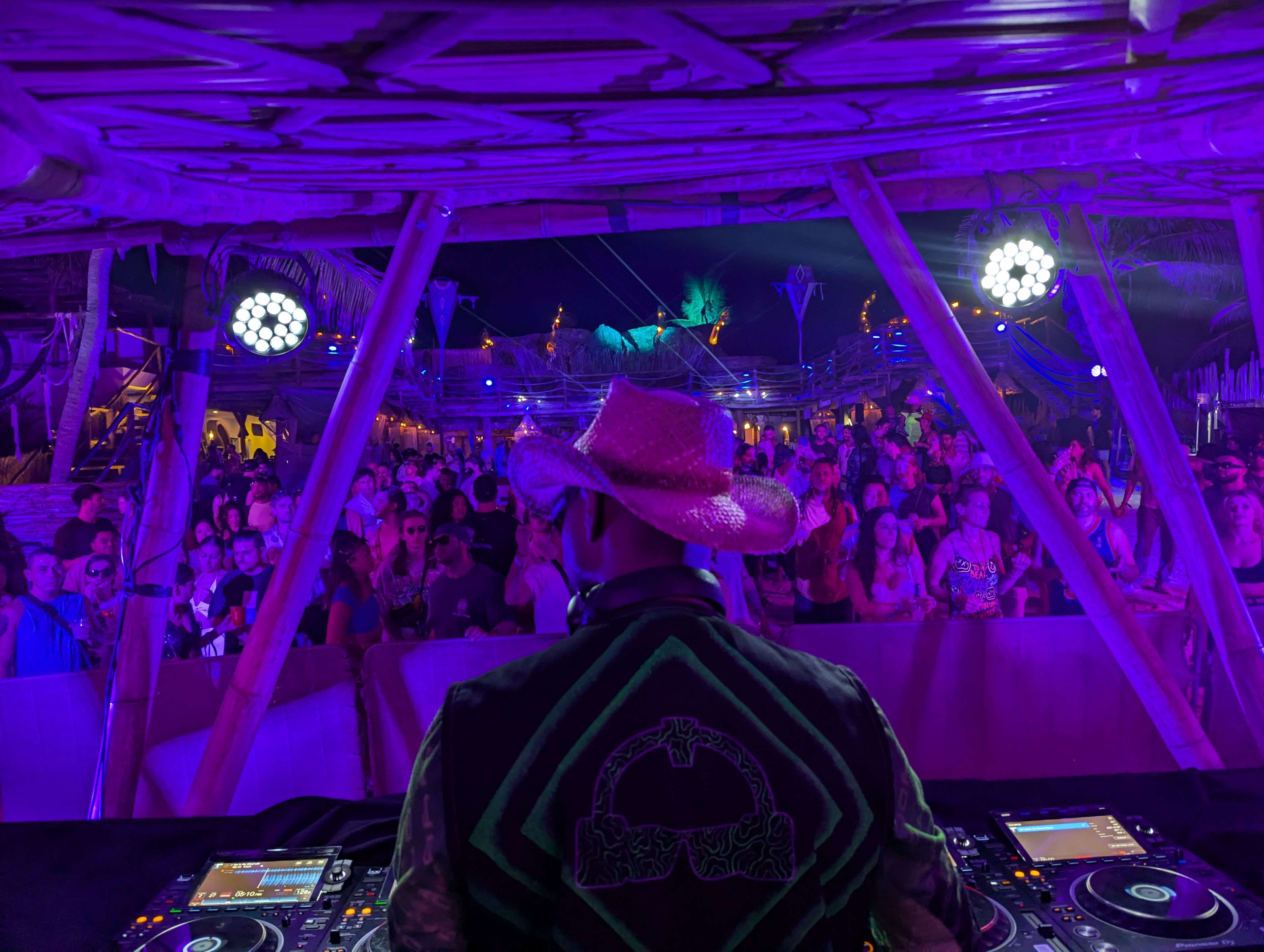 DJ performing on outdoor stage at Destination Unknown Tulum